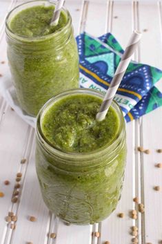 two mason jars filled with green smoothie