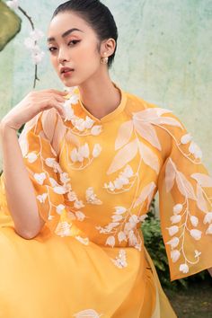 https://meanblvd.com/products/debra-white-floral-ao-dai Elegant Embroidered Ao Dai For Summer, Elegant Floral Embroidered Ao Dai For Summer, Summer Embroidered Ao Dai, Yellow Wedding Dress With Intricate Embroidery, Elegant Ao Dai With Floral Embroidery For Spring, Yellow Long Sleeve Embroidered Dress For Spring, Yellow Floral Print Dress For Wedding, Yellow Long Sleeve Embroidered Spring Dress, Summer Wedding Ao Dai With Floral Print