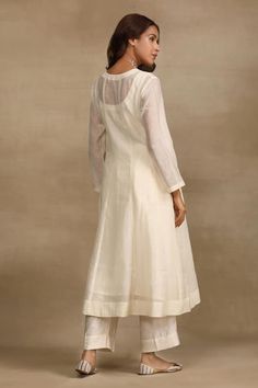 Ivory mildly pleated kurta with floral brocade motifs on the yoke. Paired with a pant and dupatta with kiran lace and mirror buttis. Comes along with an inner. - Aza Fashions Elegant Off White Kurta For Spring, Elegant Fitted Kurta With Pintucks, Elegant Off White Cotton Silk Kurta, Elegant Off White Cotton Kurta, Elegant Beige Cotton Kurta, Elegant Off-white Cotton Silk Kurta, Elegant Long Sleeve Sets With Pintucks, Brocade Motifs, Brocade Pattern