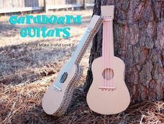 an ukulele leaning against a tree with the words garbboard guitars written on it