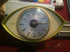 a clock with an eye shaped face on it