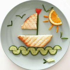 a white plate topped with slices of bread and cucumbers next to sliced oranges