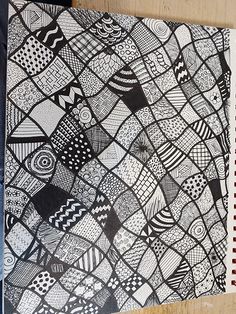 a notebook with black and white designs on it