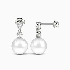 A stunning showcase of elegance and refinement, these drop earrings delight at first glimpse. Each earring features a lustrous pearl suspended with soft grace beneath a pear and round gemstone. The elegant design sways gently with your movements, gleaming subtly to draw admiring eyes. Whether worn for day or evening, the understated luxury of these drops enhances any outfit with impeccable taste and sophistication. *Each piece is handmade, resulting in a potential variance of 0.1-0.2mm during me Elegant Earrings With Timeless Design, Luxury White Drop Teardrop Earrings, Luxury White Pear-shaped Earrings, Elegant White Drop Pearl Earrings, Elegant Diamond White Teardrop Earrings, Elegant Diamond White Pear-shaped Teardrop Earrings, Luxury Pear-shaped Pearl Earrings, Elegant Pearl Teardrop Earrings For Formal Occasions, Elegant White Pear-shaped Teardrop Earrings