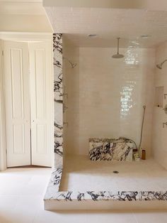 a bath room with a walk in shower