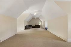 an empty room with white walls and carpeted flooring is seen in this image