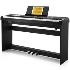 a black piano with an electronic keyboard on it