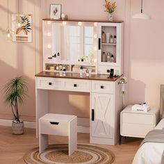 a white vanity with lights on it in a bedroom next to a bed and table