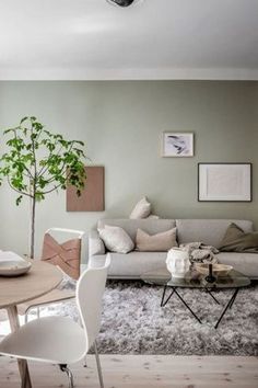 a living room filled with furniture and a tree in the middle of it's center