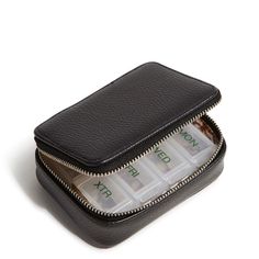 an empty black wallet with four compartments on the front and one in the back that is filled with money