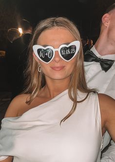 a woman wearing heart shaped sunglasses with the word w o n d on it