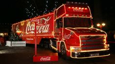 a coca - cola truck is decorated with christmas lights and decorations for the holiday season