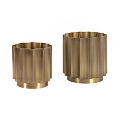 two brass vases sitting next to each other on a white background, one is empty