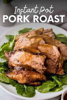 meat and greens on a white plate with sauce in a small bowl next to it