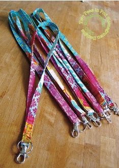 several lanyards are lined up on a wooden table