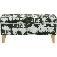 an upholstered bench with green and white paint splattered on the fabric