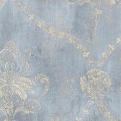 a blue and gold wallpaper with an ornate design on it's surface,