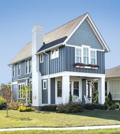 a blue house with white trim and windows