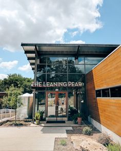 the front entrance of a building that has a sign on it saying the learning pear