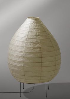 a large white paper lantern sitting on top of a metal stand