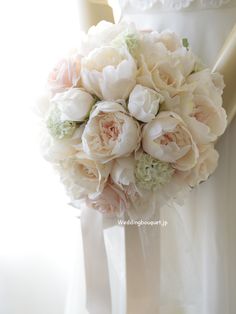 the bride's bouquet was made up of white and pink peonies