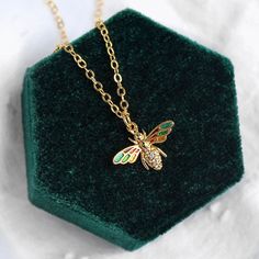 This necklace features a colorful little bee charm on a 16" 24k gold plated chain. The bee has colorful wings emulating stained glass and embedded gemstones on the body. Whimsical Gold Pendant Charm Necklace, Whimsical Gold Vintage Charm Necklace, Bee Accessories, Bee Jewelry Gold, Colorful Wings, Bee Necklace Cute, Bee Cottage, Bee Things, Bee Pendant Necklace