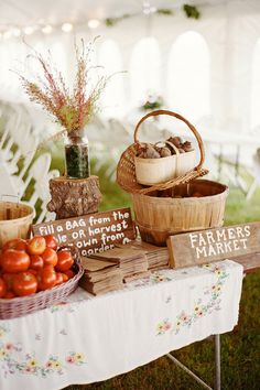 a table topped with baskets filled with tomatoes and other fruits next to a sign that says, all bag from the farmer's market