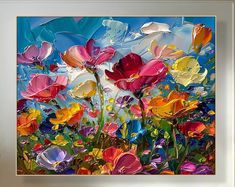 an oil painting of colorful flowers in a white frame on a blue sky and green grass background