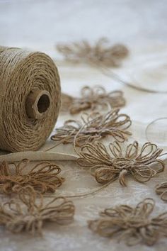 a spool of twine with some flowers on it