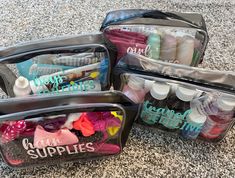 four clear storage bags filled with supplies on top of a carpeted floor next to each other