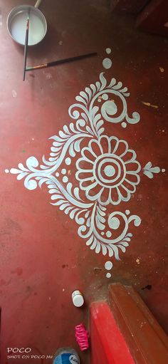 the floor is painted with white paint and has a flower design on it, along with other items