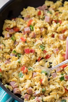 a skillet filled with scrambled eggs and ham