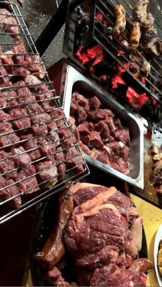 various meats and other foods being cooked on grills