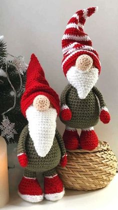 two crocheted gnomes sitting next to each other on top of a basket