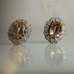 Beautiful Topaz and Diamond Cluster Earrings circa 1940. Each earring has a central, claw set, oval cut topaz which is complemented by twelve claw set old cut diamonds forming an outer border, in a decorative extended claw 18ct yellow gold pierced out gallery.  To the reverse the topaz and diamonds are set into open backed settings, this allows the light to shine through. The Earrings measure 10 mm width by 12.5 mm length Stone:                         Topaz/Diamond Carat: Diamond Cluster Earrings, Gold Topaz, Diamond Carat, Platinum Ring, Diamond Cluster Ring, Cluster Earrings, Ring Photos, Earrings Vintage, Diamond Cluster