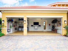 an open garage with two bicycles parked in the front and one bicycle on the back