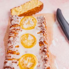 a piece of bread with lemons on it next to a knife