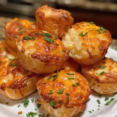 small baked items on a white plate with parsley sprinkled around them, ready to be eaten