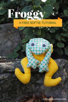 a stuffed animal sitting on top of a rock next to some leaves and bushes with the title froggy a free softie sewing pattern