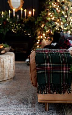 a living room filled with furniture and a christmas tree in the backgroung