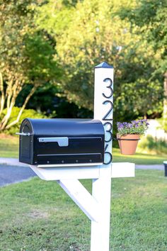 a mailbox sitting on top of a white post