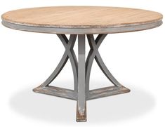 an old wooden table with metal legs and a round top, on a white background