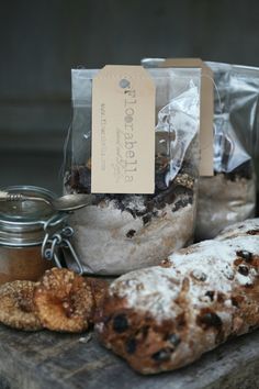 some bread and other food items on a wooden table with a tag hanging from it