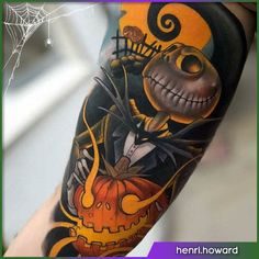 a person with a halloween themed tattoo on their arm