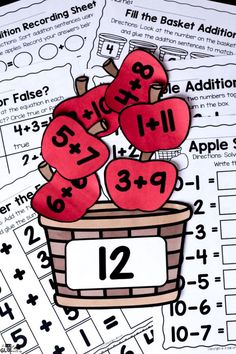 two apples in a basket with numbers on it and the word addition is cut out