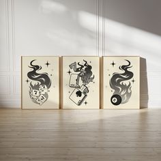 three canvases with different designs on them in an empty room