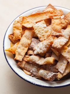 a white bowl filled with fried food on top of a table