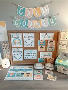 a bulletin board with pictures and magnets on it next to a wooden box that says calm corner