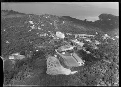 an aerial view of a large building surrounded by trees