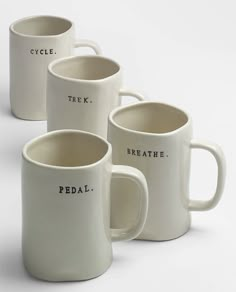 four white coffee mugs with the words pedal written in black ink on them